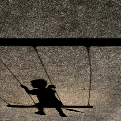 Shadow of child on swing